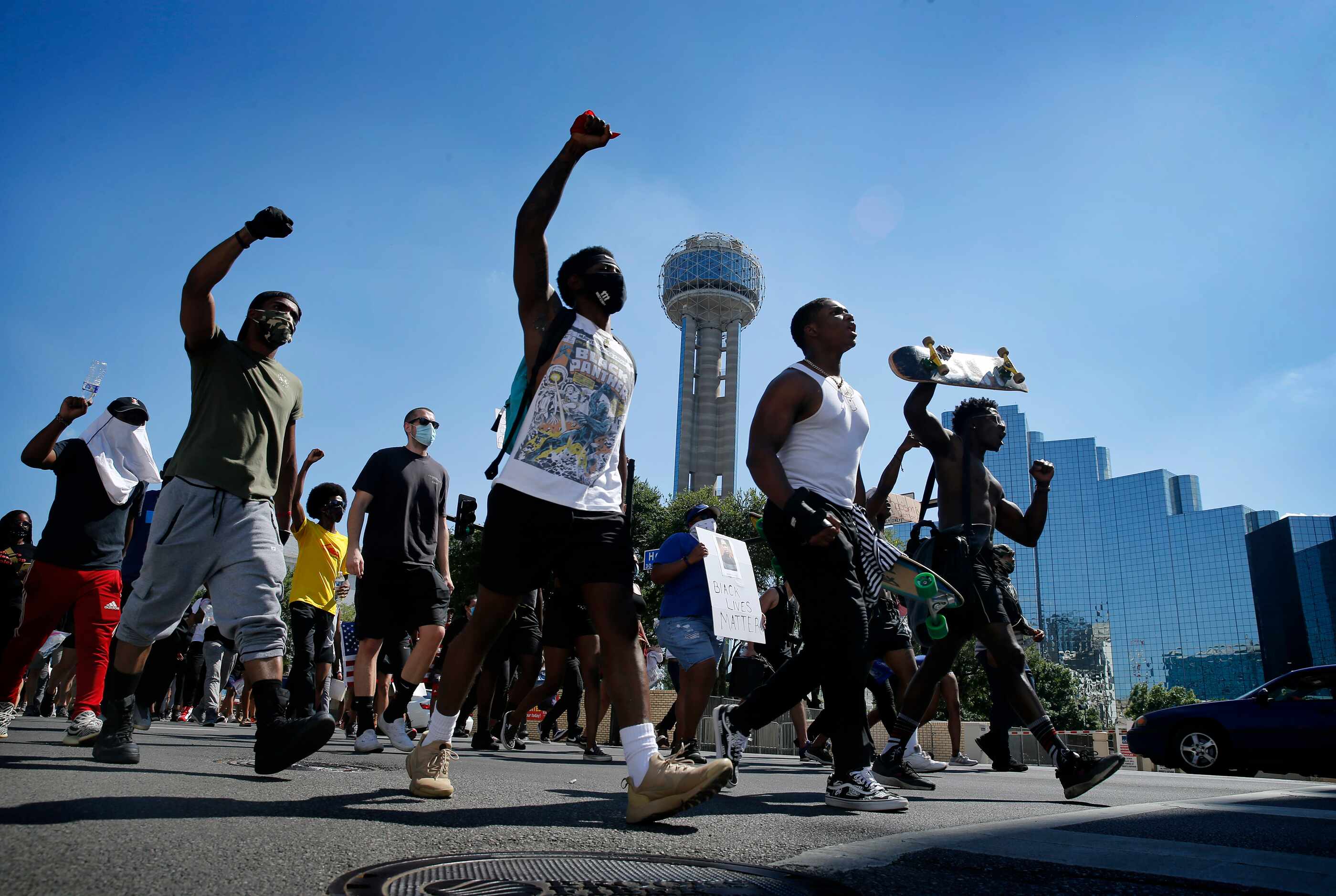 Protestors supporting Black Lives Matters rally march past Reunion Tower on their way to...
