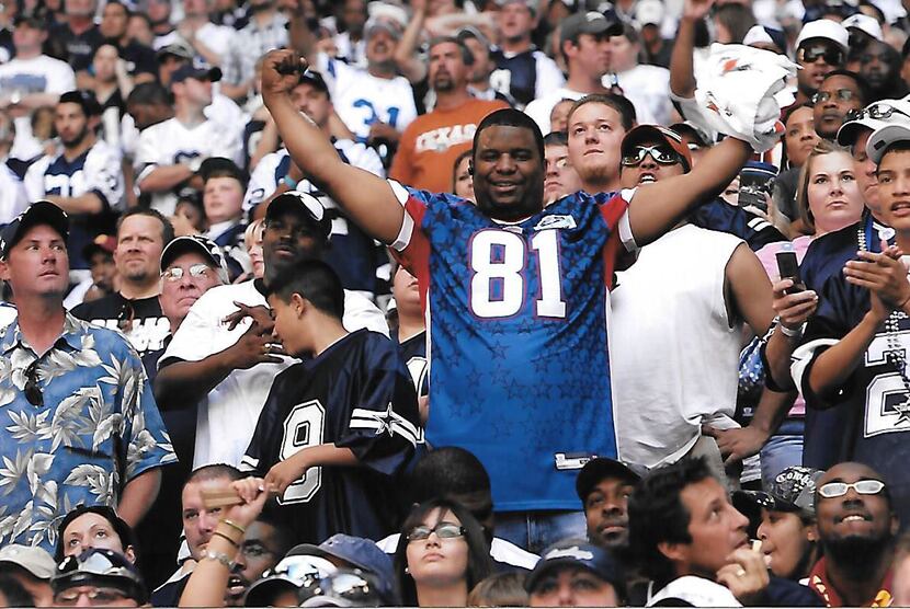 Sporting his Terrell Owens pro bowl jersey, Cowboys superfan Tony Holmes (center) gets fired...