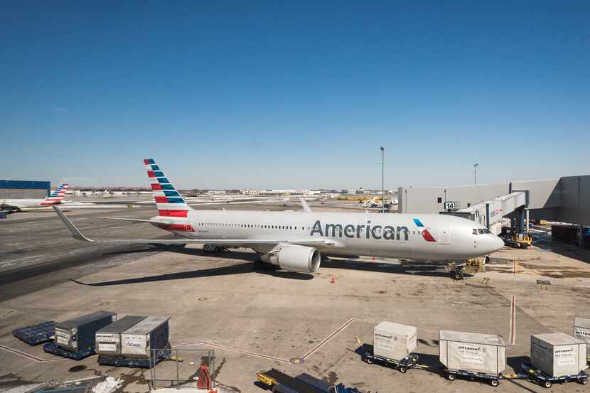 An American Airlines jet waits at a gate at John F. Kennedy International Airport in New York.