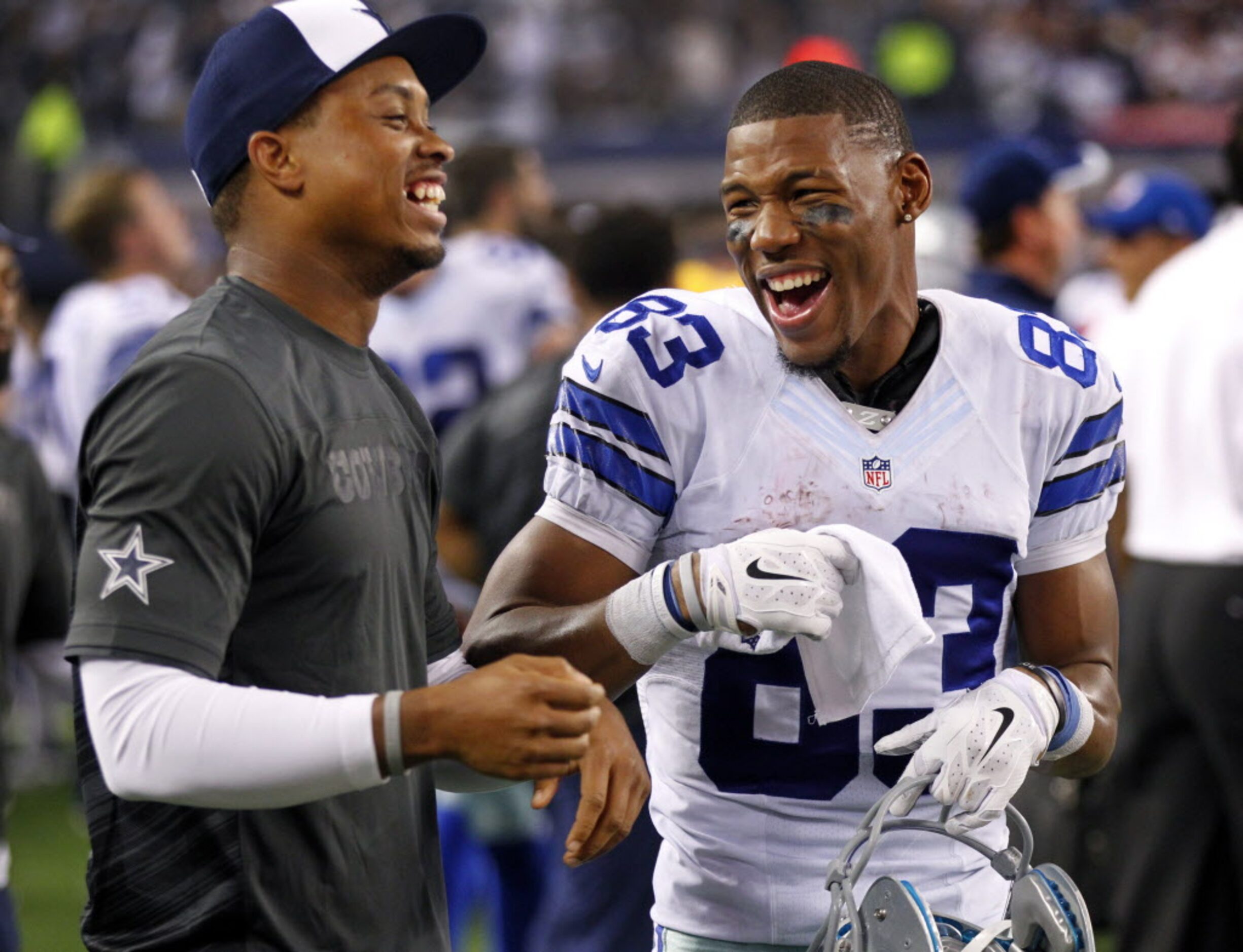 Dallas Cowboys wide receiver Terrance Williams (83)and laughs with his teammate on the...