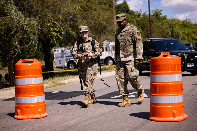 Members of the US Air Force leave the site where a military training aircraft crashed in a...