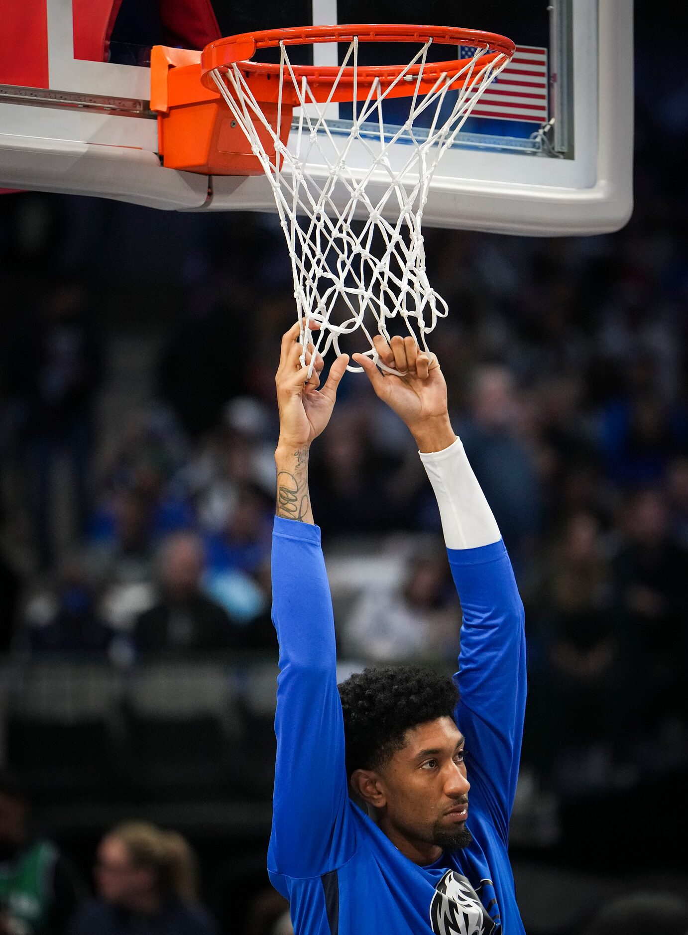 Dallas Mavericks center Christian Wood stretches before an NBA basketball game against the...