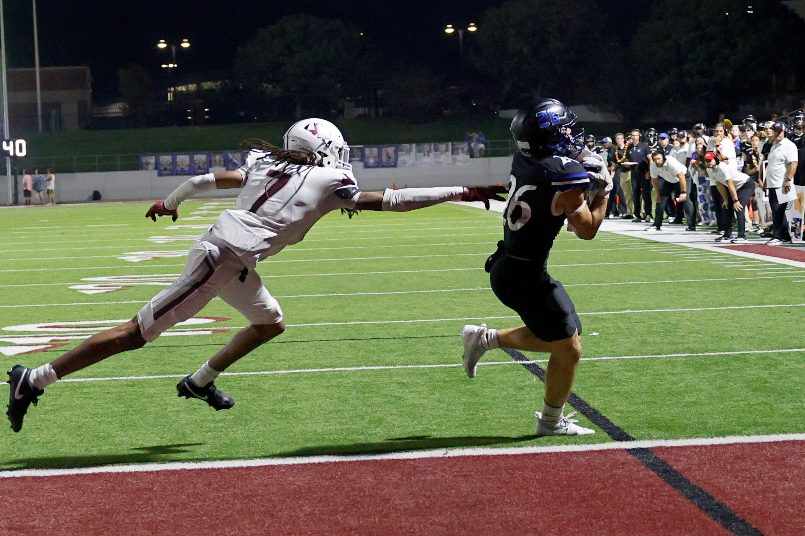 Byron Nelson's Tucker James (26) scores a touchdown over Lewisville's Taelyn Mayo (7) during...