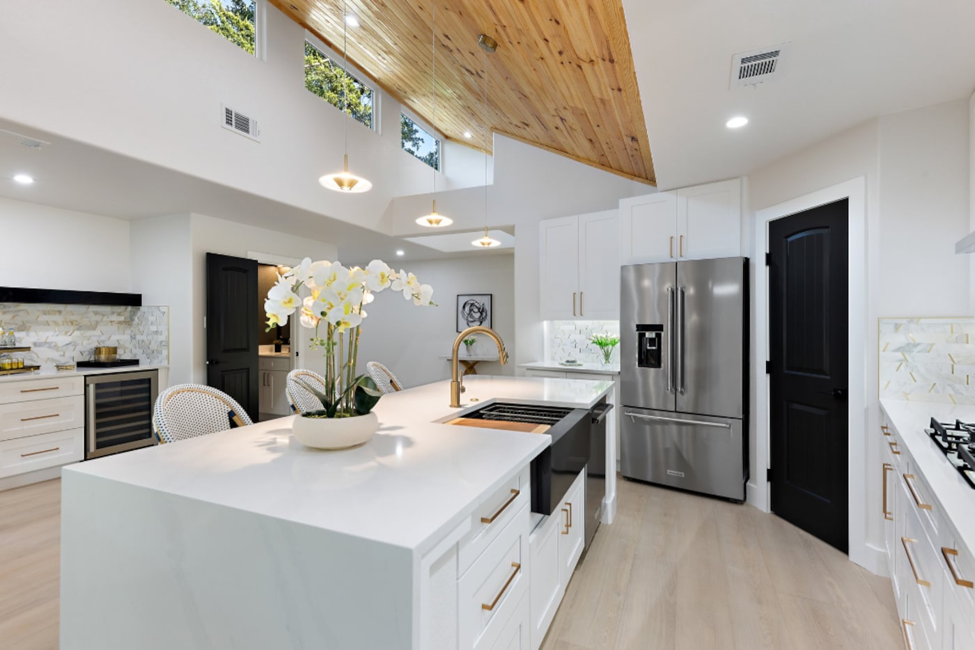 White kitchen with wood ceiling and transom windows