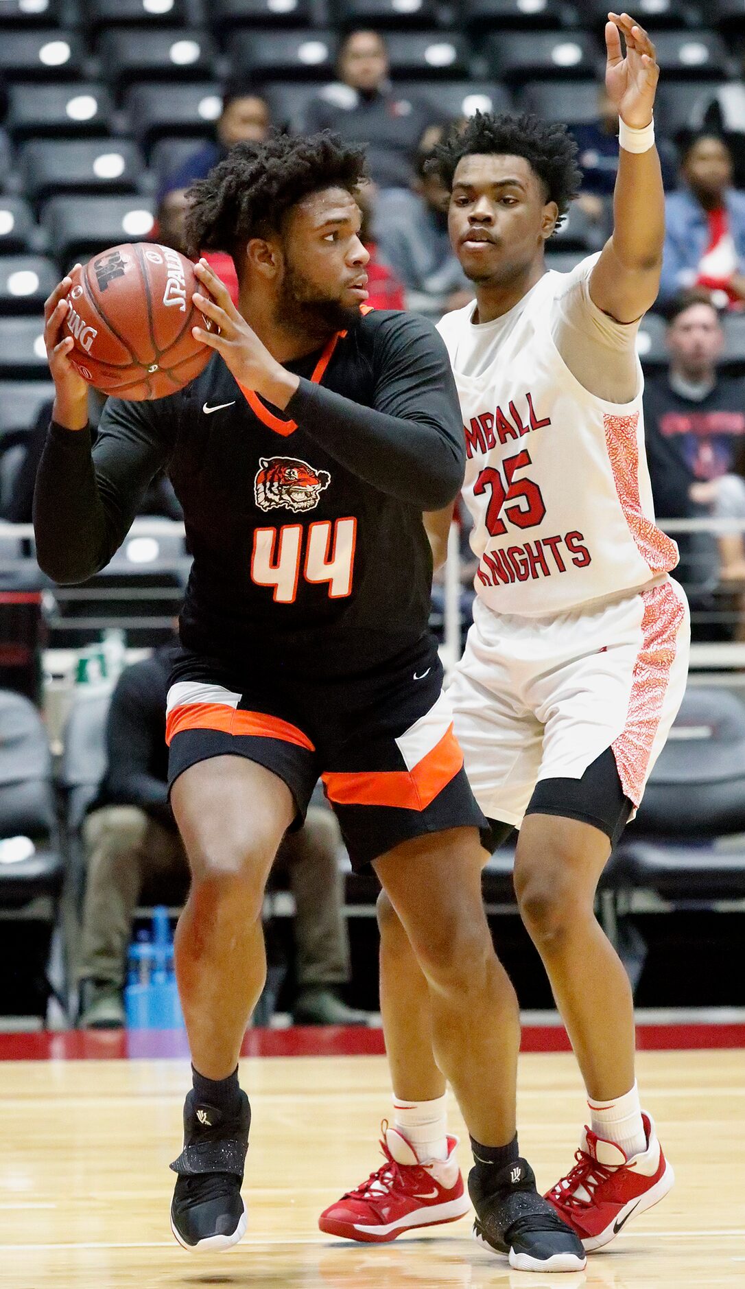 Lancaster High School forward Kentrell Hall (44) looks to pass around Kimball High School...