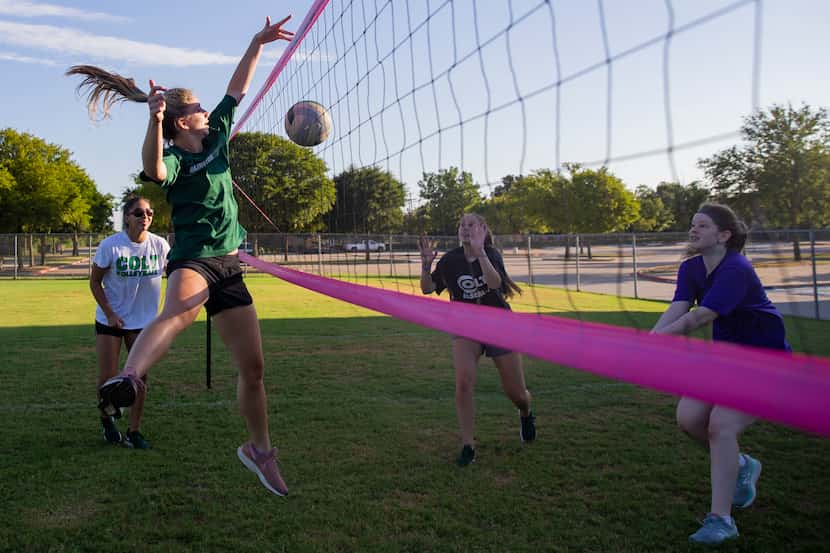 The Arlington High volleyball team practices on its grass court Thursday morning. The team...