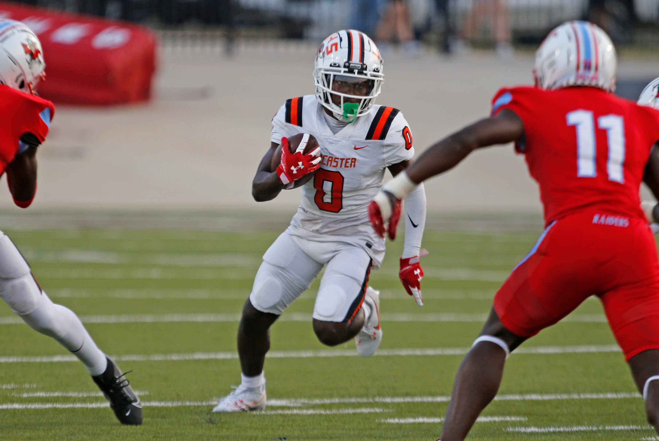 Lancaster High’s Ti’Erick Martin (0) advances the football during the first half of a high...