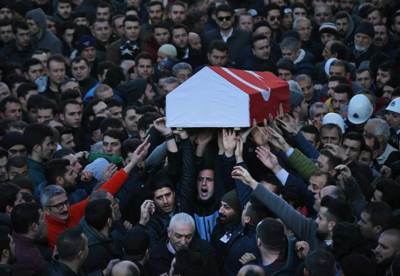 Mourners chanted slogans as they carried the Turkish flag-draped coffin of Yunus Gormek, 23,...