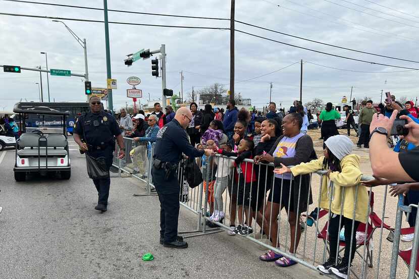 Dallas Police Chief Eddie Garcia handed out candy and introduced himself to families along...