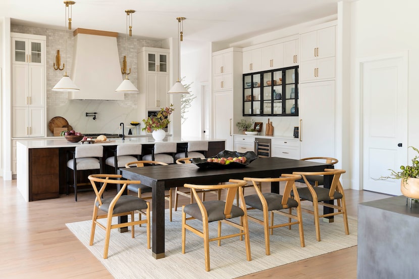 Kitchen with table in foreground with carpet tiles that look like a rug