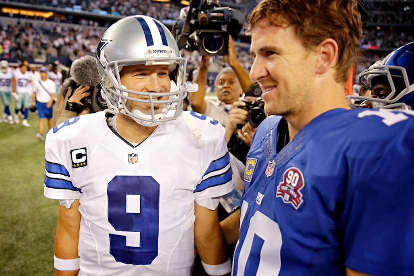 Dallas Cowboys quarterback Tony Romo (9) smiles as he talks with New York Giants quarterback...