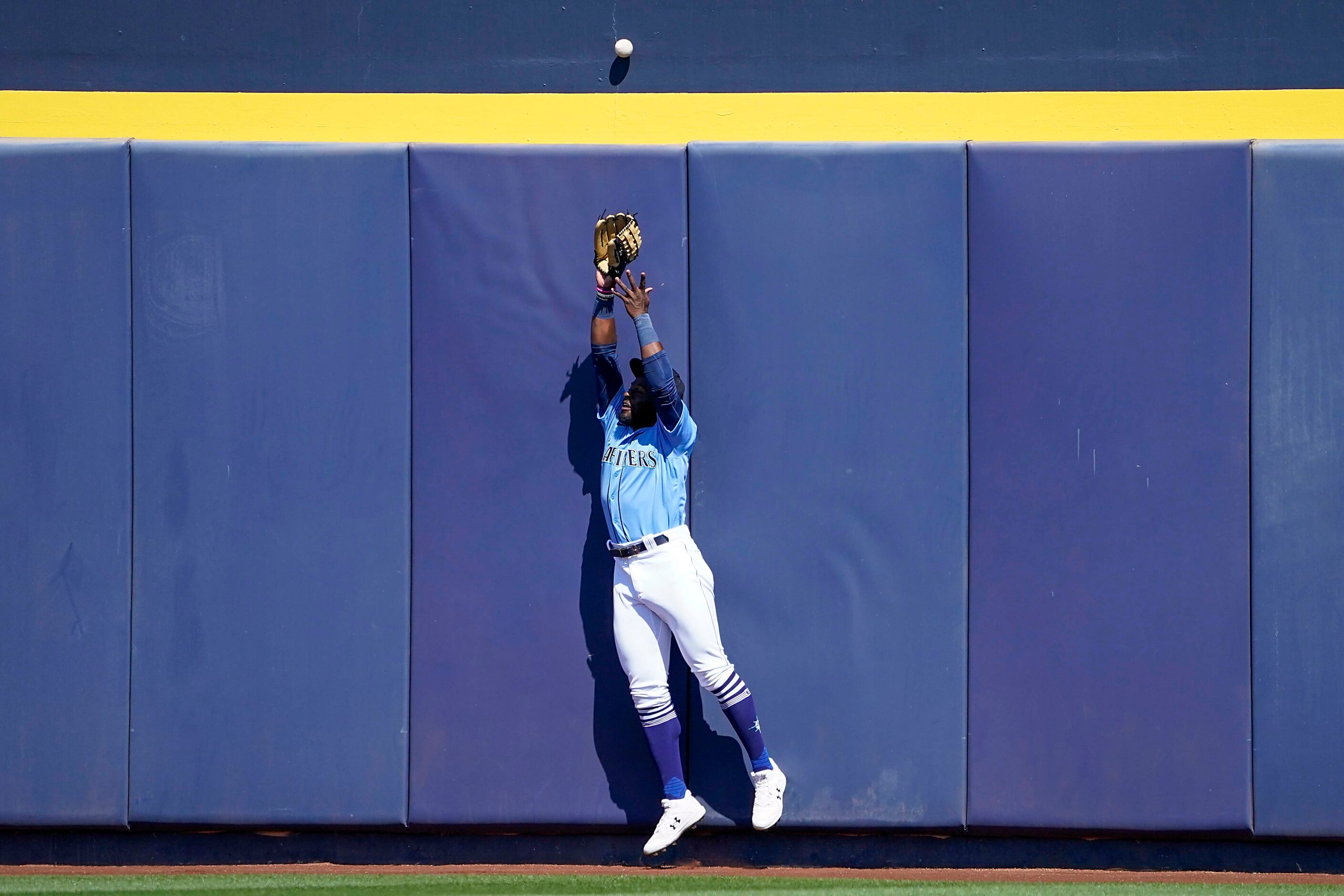 Seattle Mariners center fielder Taylor Trammell can’t make the play on a 2-run home run...