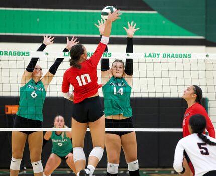 Southlake Carroll junior senior Mary Beth Morse (6) and sophomore Kinsley Young (14) jump to...