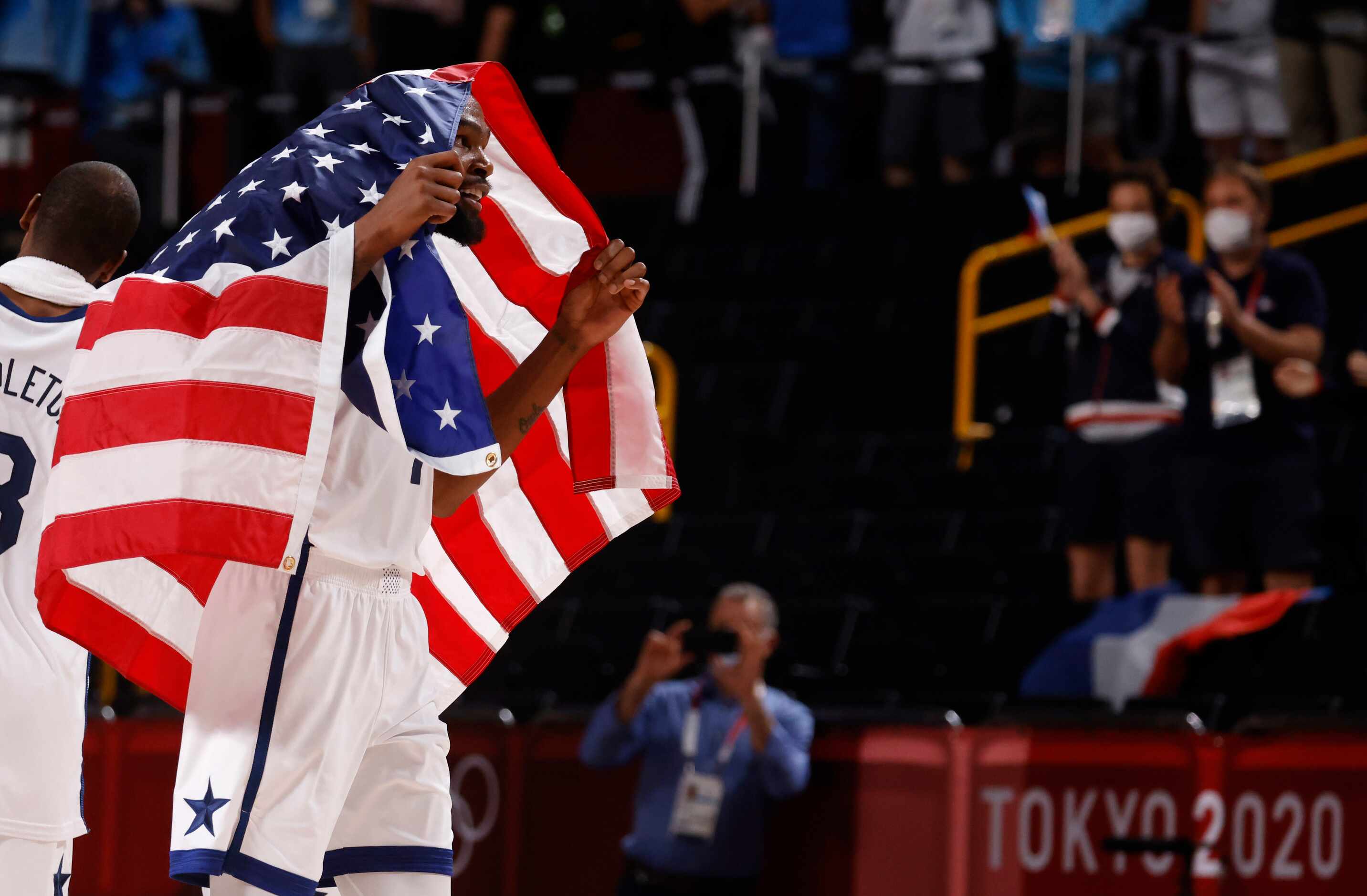 USA’s Kevin Durant (7) celebrates with a flag draped on him after USA defeated France in the...