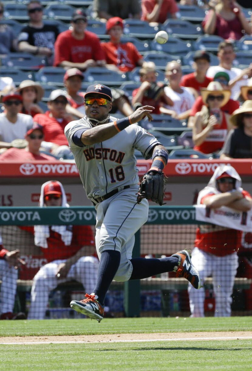 Houston Astros' Luis Valbuena throws the ball to first base for the out on Los Angeles...