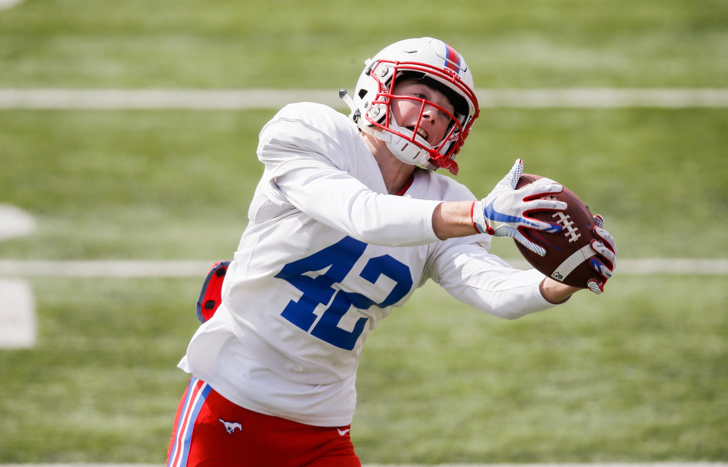 SMU wide receiver Beau Barker (42) catches a pass during practice at Gerald Ford Stadium,...
