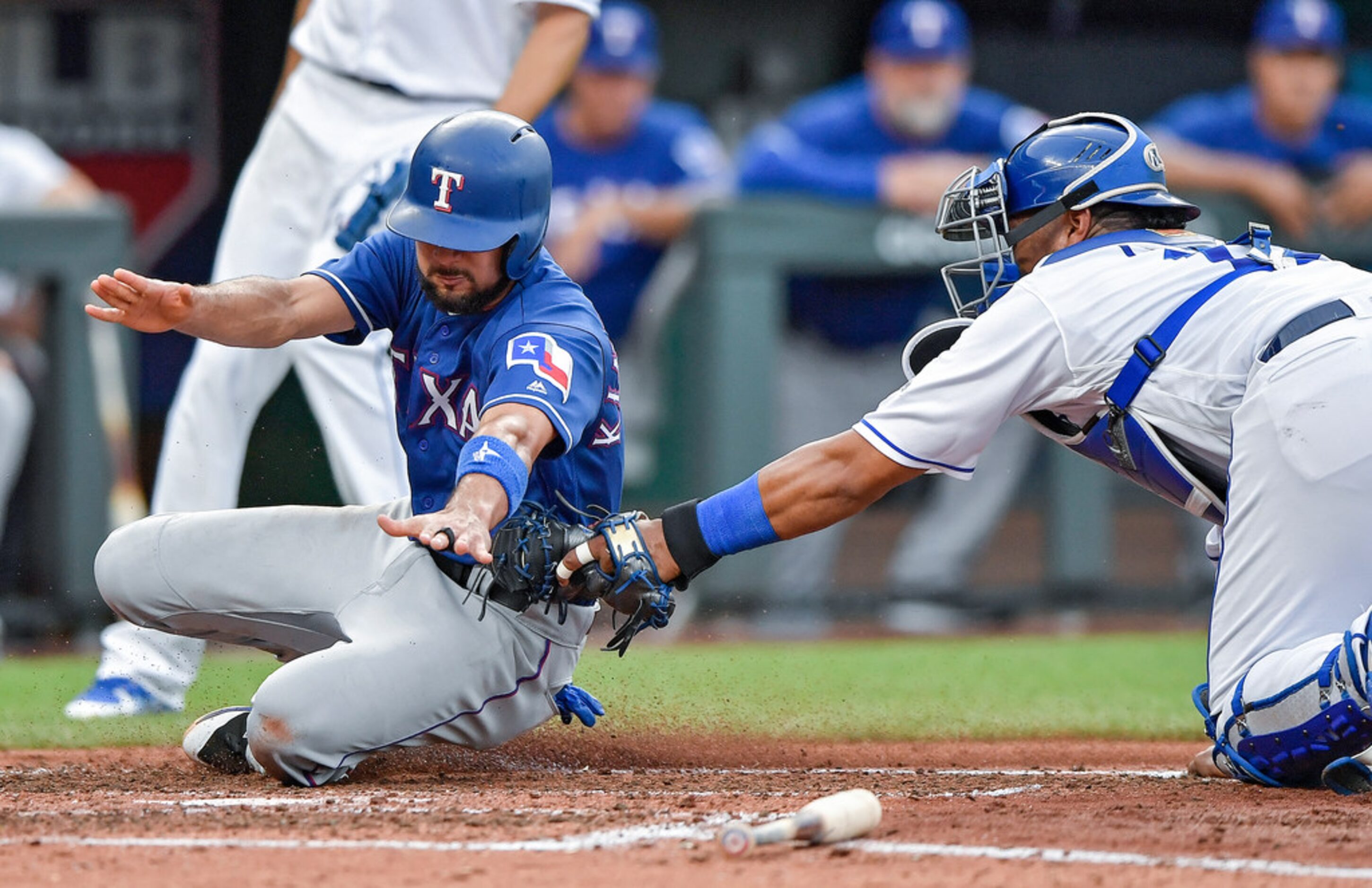 Kansas City Royals catcher Salvador Perez tags out the Texas Rangers' Isiah Kiner-Falefa at...