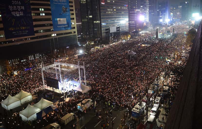 South Koreans take to the streets in the city center to demand President Park Geun-Hye to...
