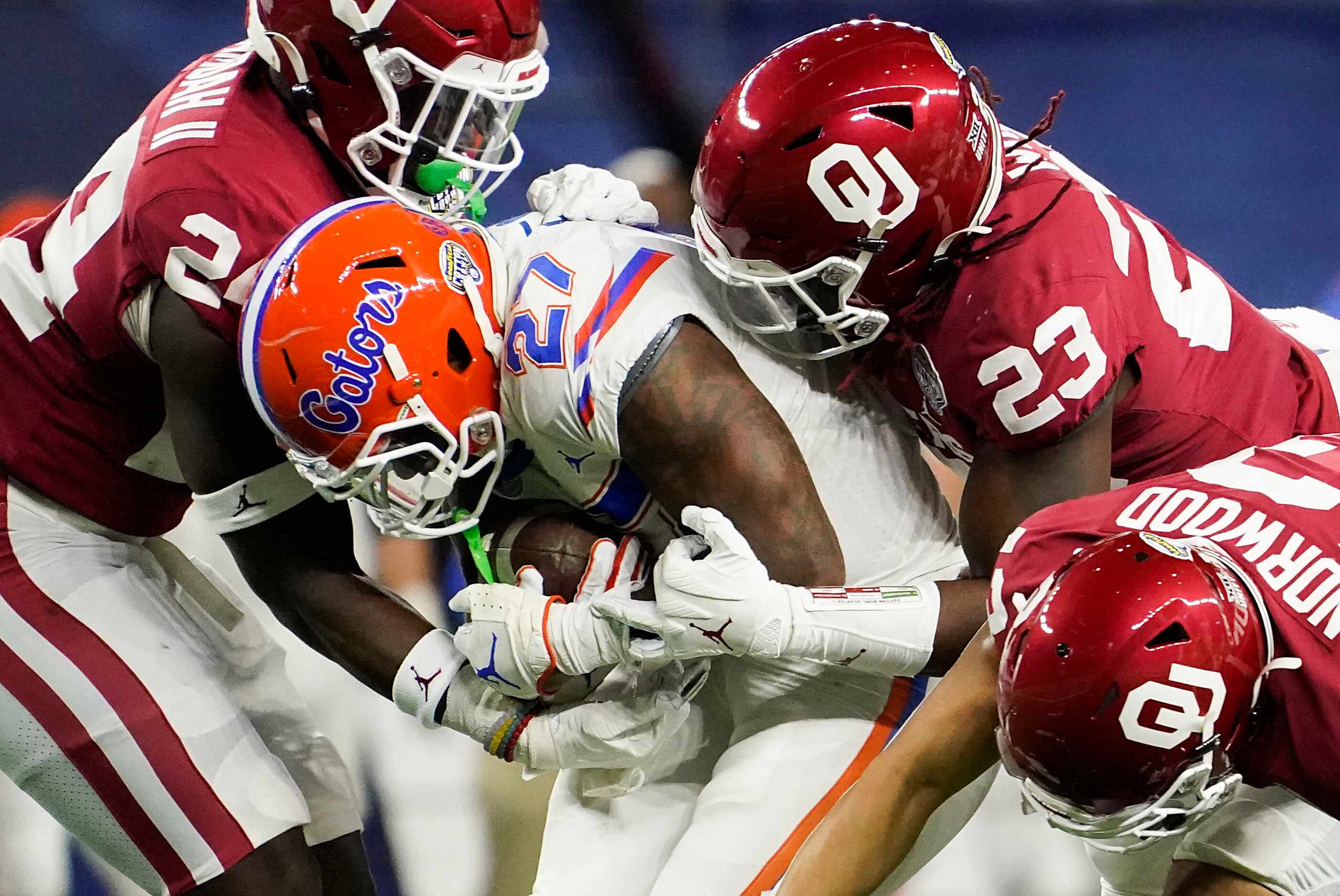 Florida running back Dameon Pierce (27) is wrapped up by Oklahoma linebacker Brian Asamoah...