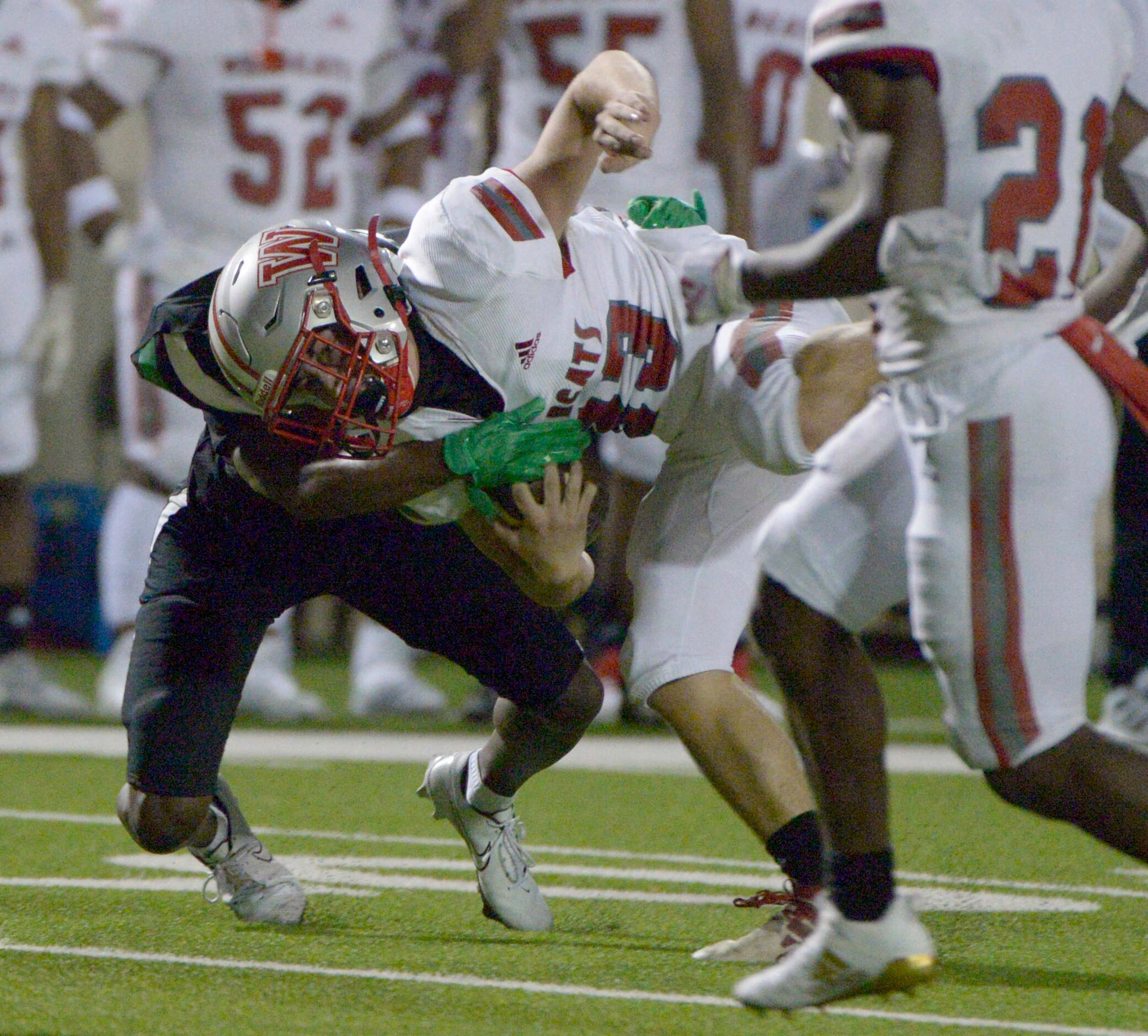 Woodrow Wilson’s Nathan Barrilleaux is tackled by Berkner’s J’Braun Brown in the second...