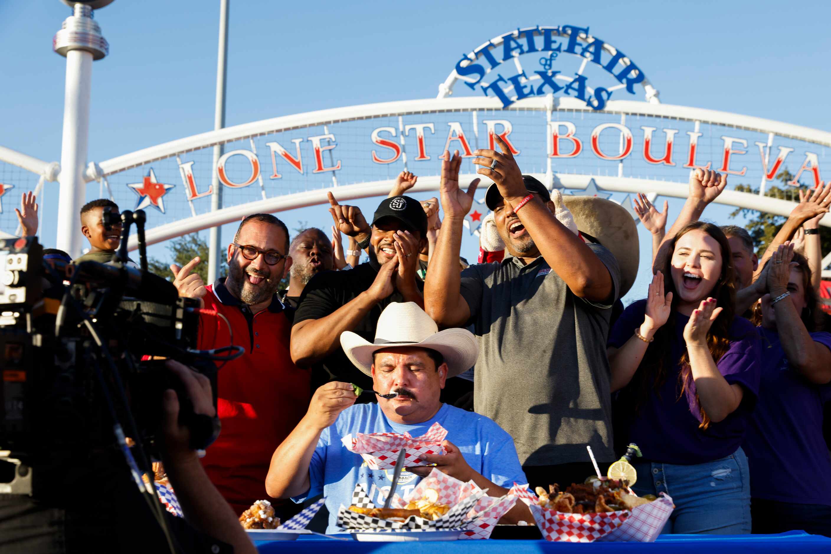 Big Tex Choice Award finalists cheer as Guillermo Rodriguez, center, tries one of the award...