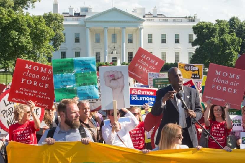 Protesters hold up signs during a demonstration in front of the White House in Washington,...