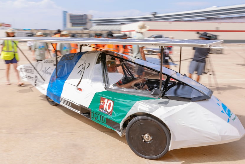 Grant Bisaillon of the Prosper Engineering Club smiles as he test drives a solar car at...