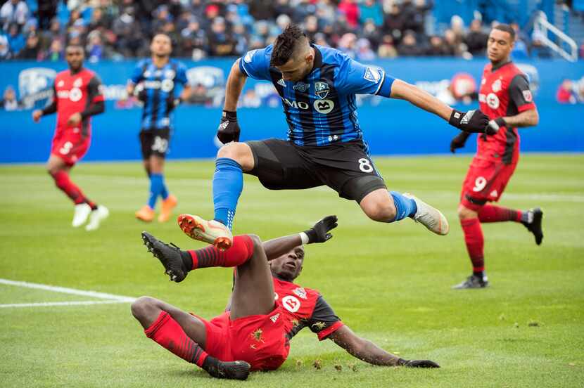 Montreal Impact's Saphir Taider (8) leaps over Toronto FC's Chris Mavinga during first-half...