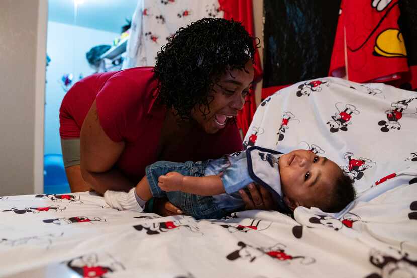 Roshell Johnson, 36, interacts with her baby Masiah Johnson after he woke up from a nap at...