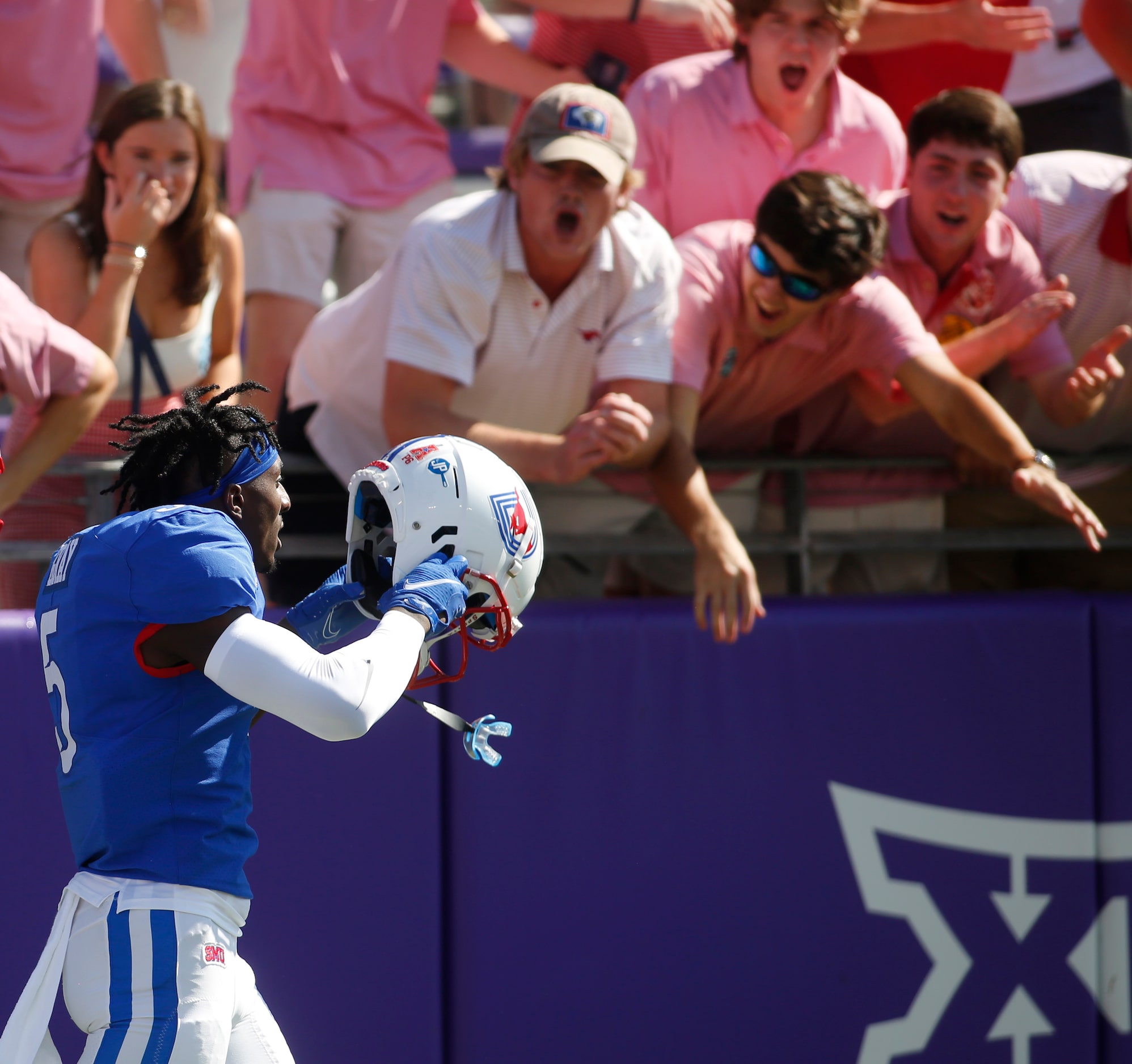 SMU receiver Danny Gray (5) walks past a jubilant group of Mustangs fans after a long...