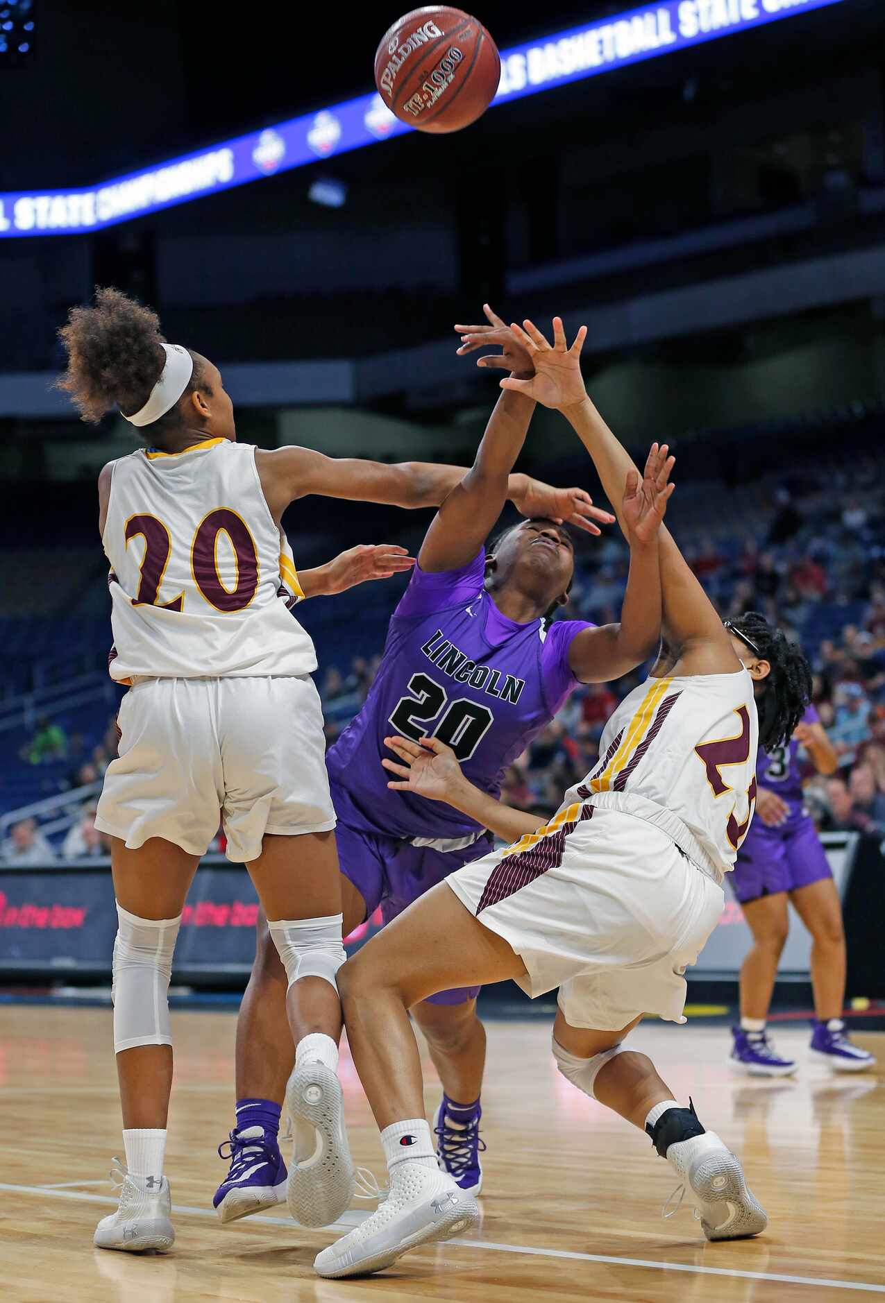 Lincoln guard Nakia Brumley (#20) is hammered by Fairfield guard Shadasia Brackens (#20) and...