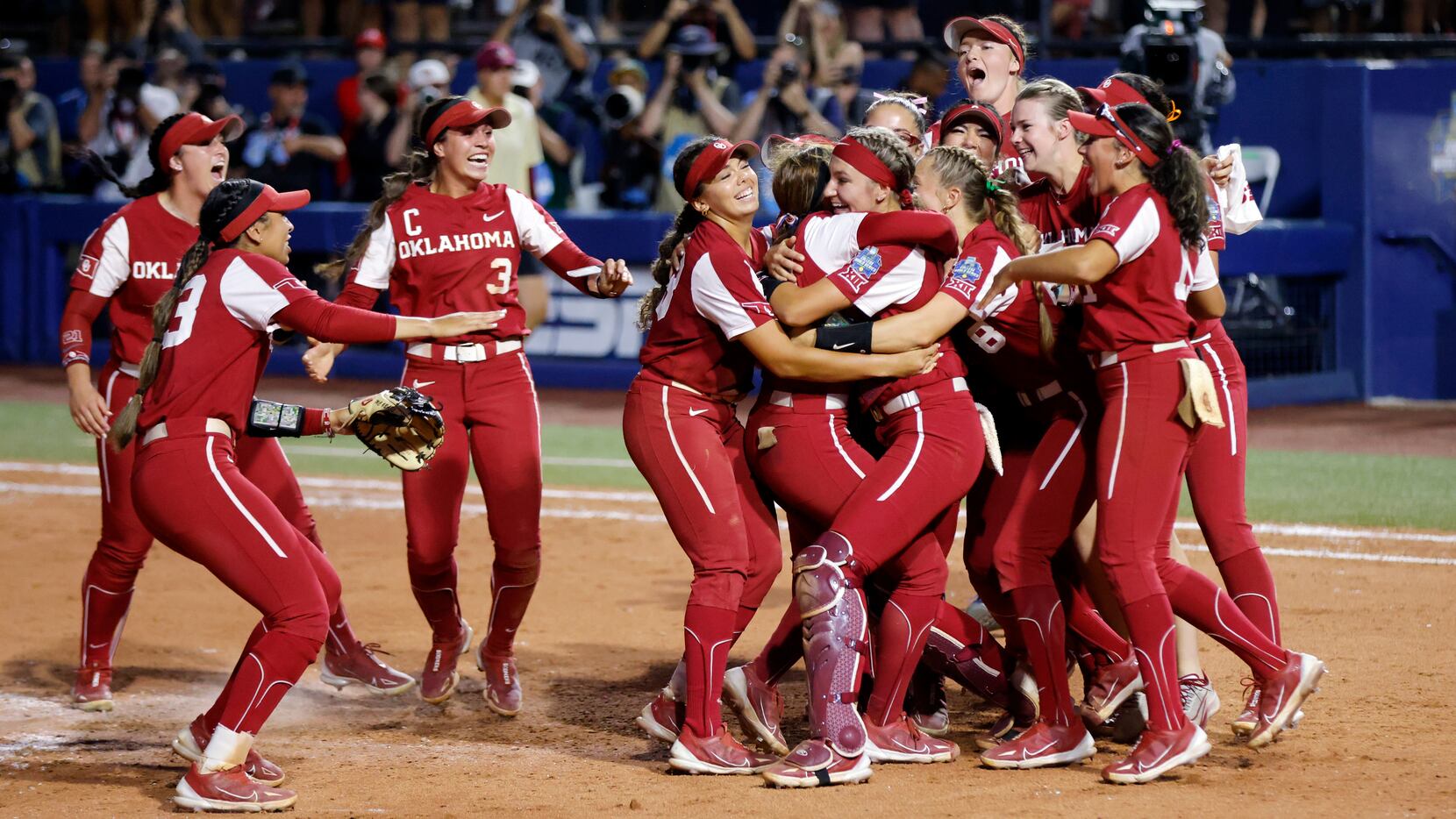 Oklahoma players celebrate after winning the second game of the NCAA Women's College World...