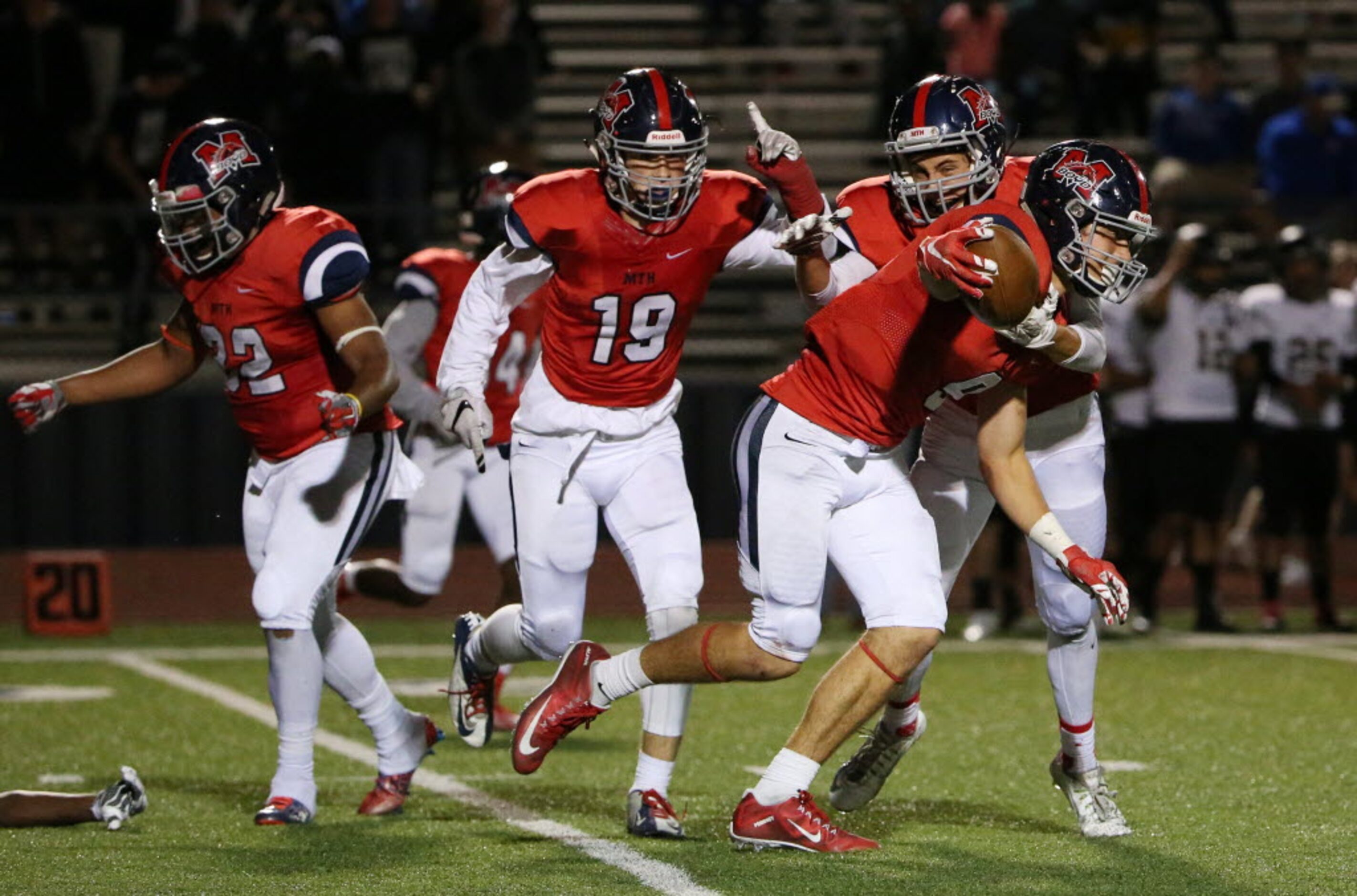 McKinney Boyd defensive back Parker Noren (9) celebrates with teammates after intercepting a...