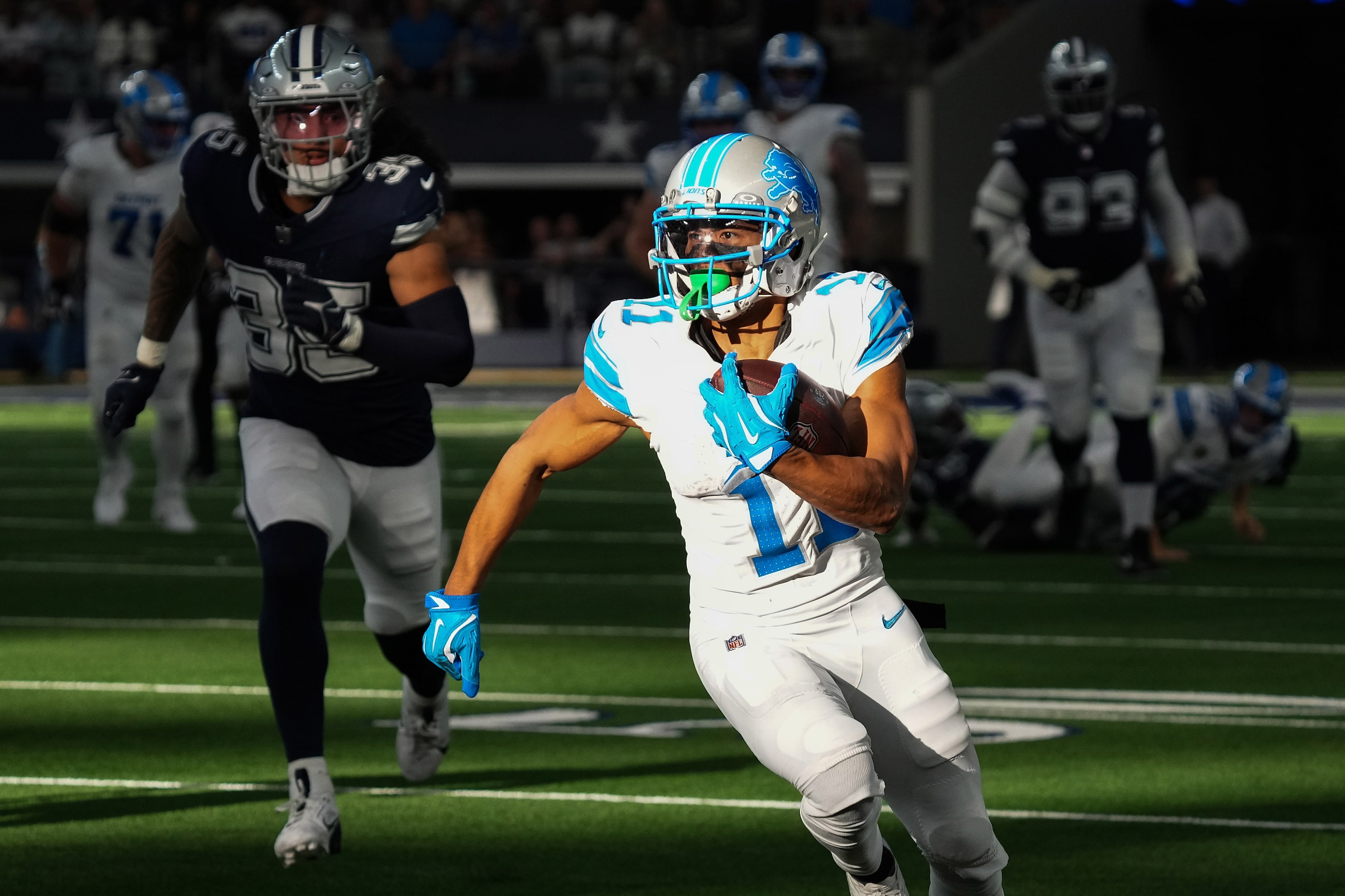 Detroit Lions wide receiver Kalif Raymond (11) picks up a first down past Dallas Cowboys...