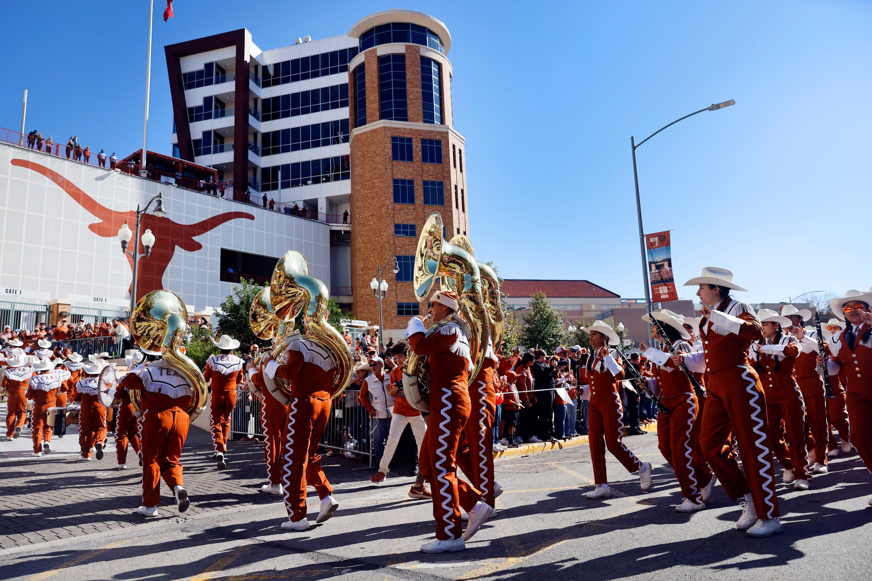 The Texas Longhorn Band arrives for the CFP first round playoff game outside Darrell K...