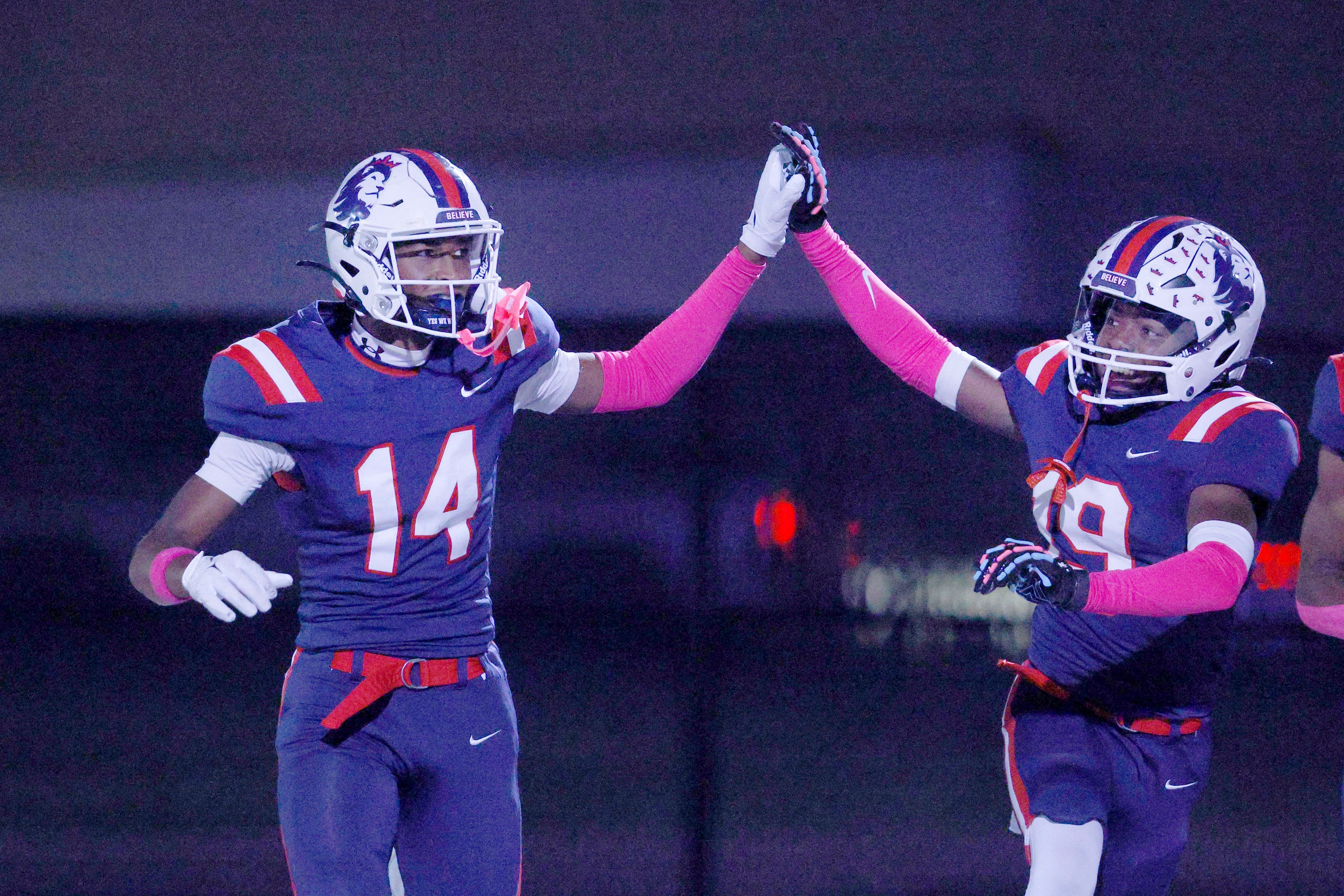 Richland's Xavier Johnson (14) celebrates with his teammate Ben Sanders (19) after scoring a...