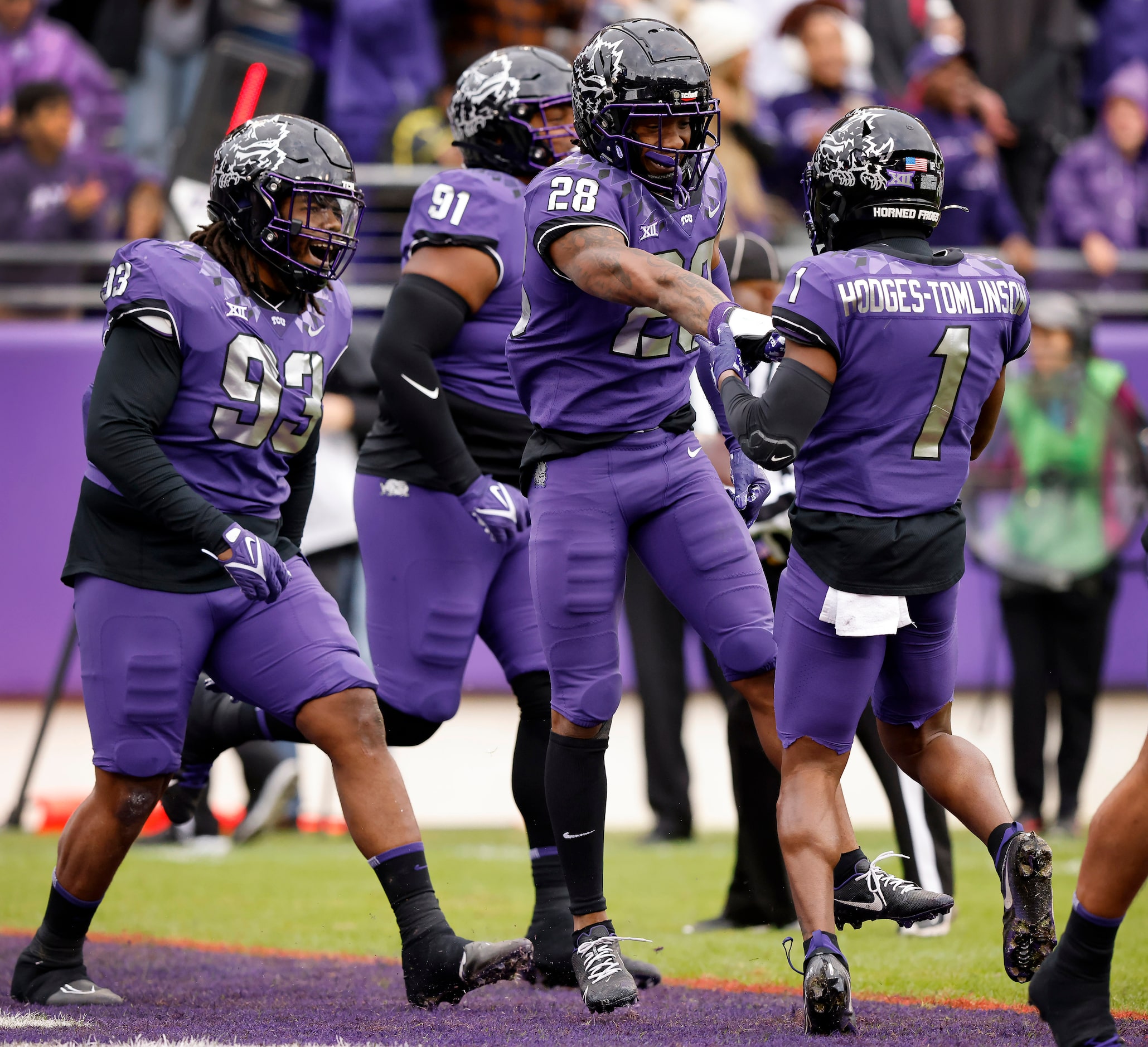 TCU Horned Frogs safety Millard Bradford (28) is congratulated by teammates after returning...