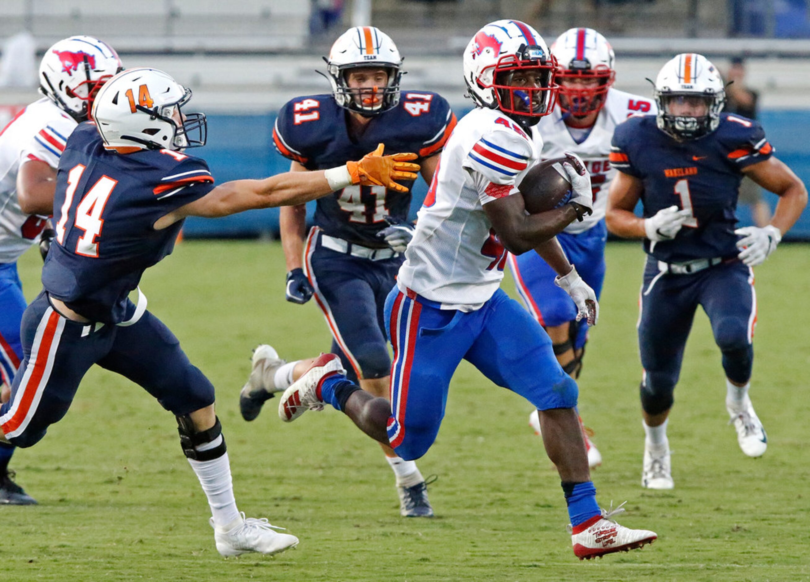 Richardson Pearce High School running back DeQuan Landon (45) gets past Frisco Wakeland High...