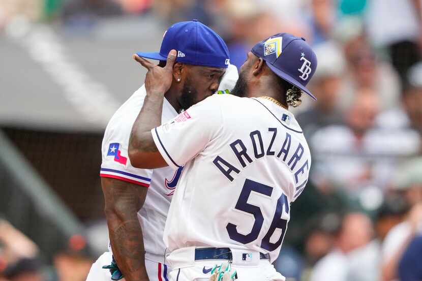 American League's Randy Arozarena, of the Tampa Bay Rays, wipe the face of Adolis Garcia of...