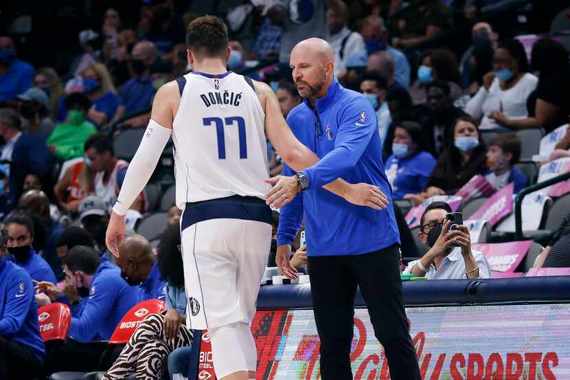 Dallas Mavericks head coach Jason Kidd (right) gives encouragement to guard Luka Doncic (77)...
