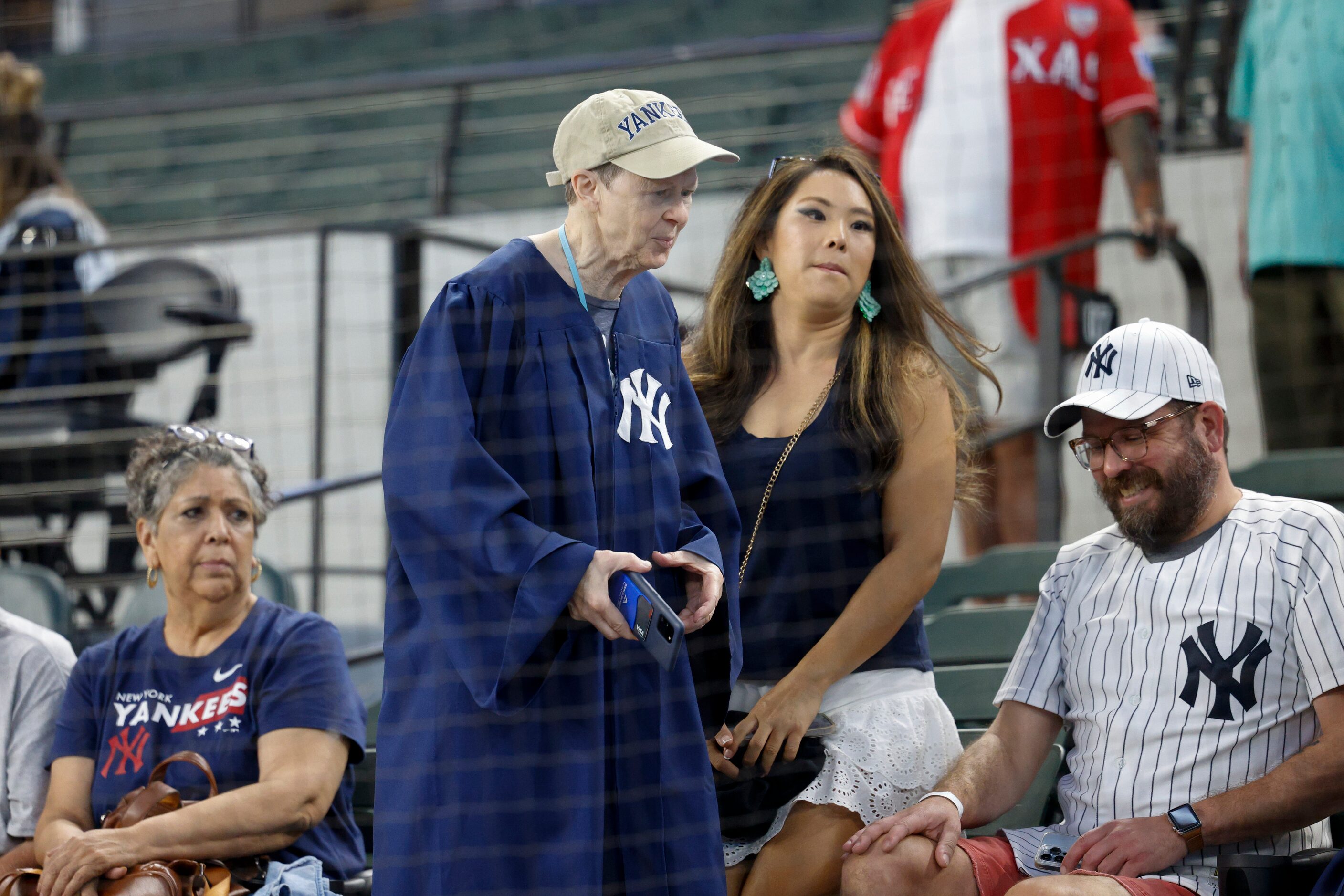 A fan wears a judge’s robe before a MLB game between the New York Yankees and Texas Rangers...