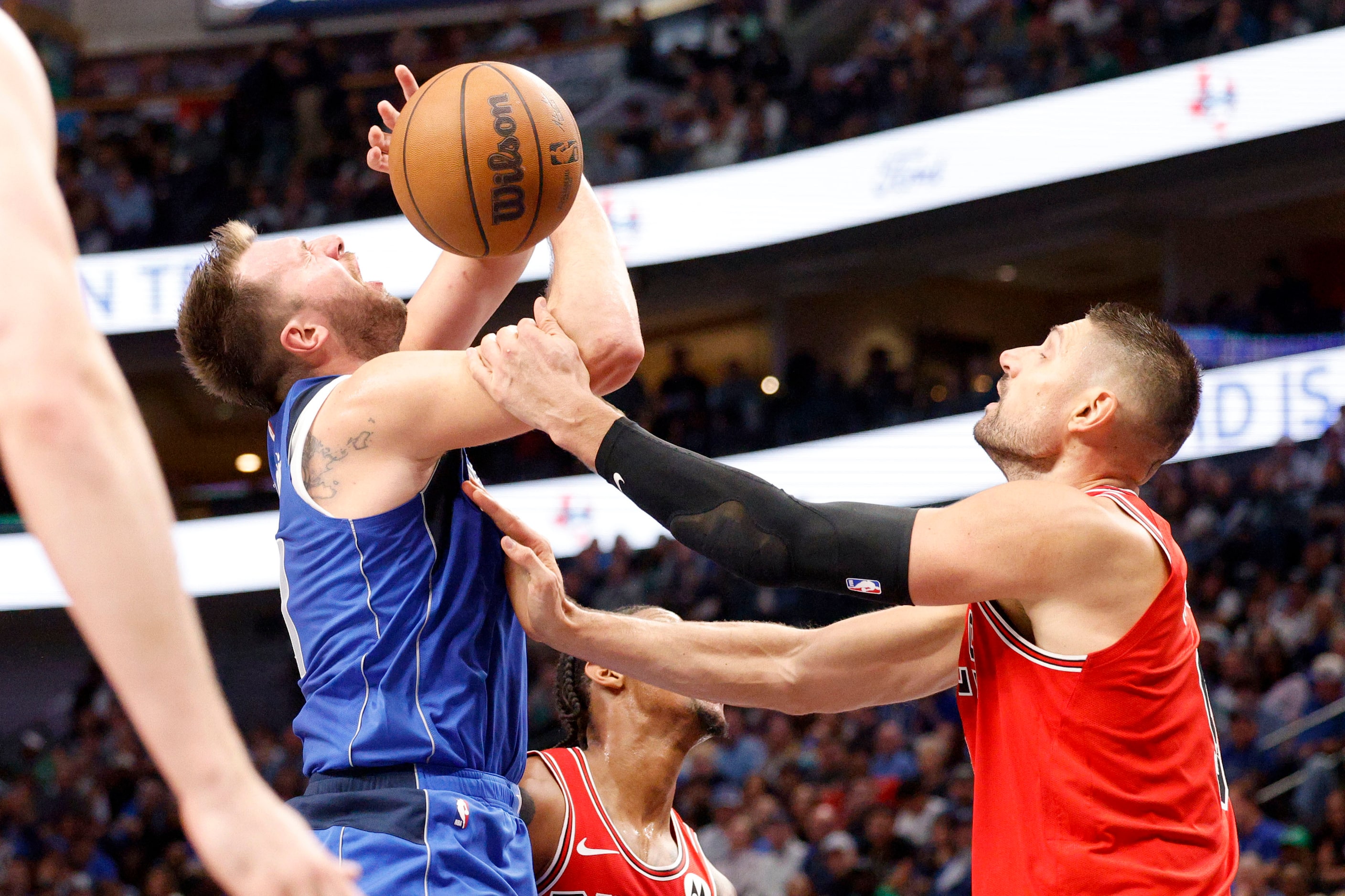 Chicago Bulls center Nikola Vucevic (9) tries to stop Dallas Mavericks guard Luka Doncic...