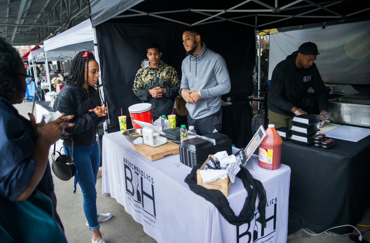 Jherron Sutton of Dallas, left,  orders a plate to go from Cornelius Malik Washington,...