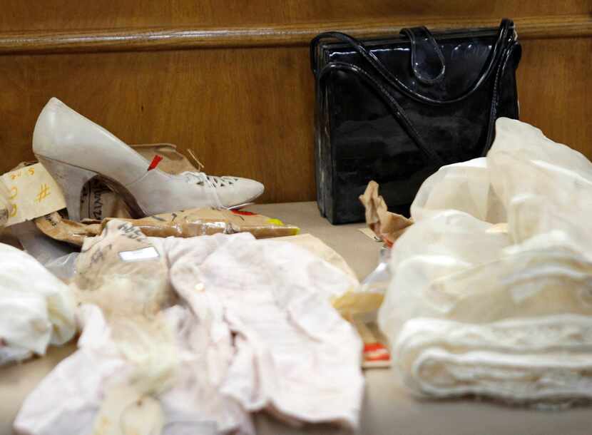 Clothing and items belonging to Irene Garza are displayed on a table during John Feit's...