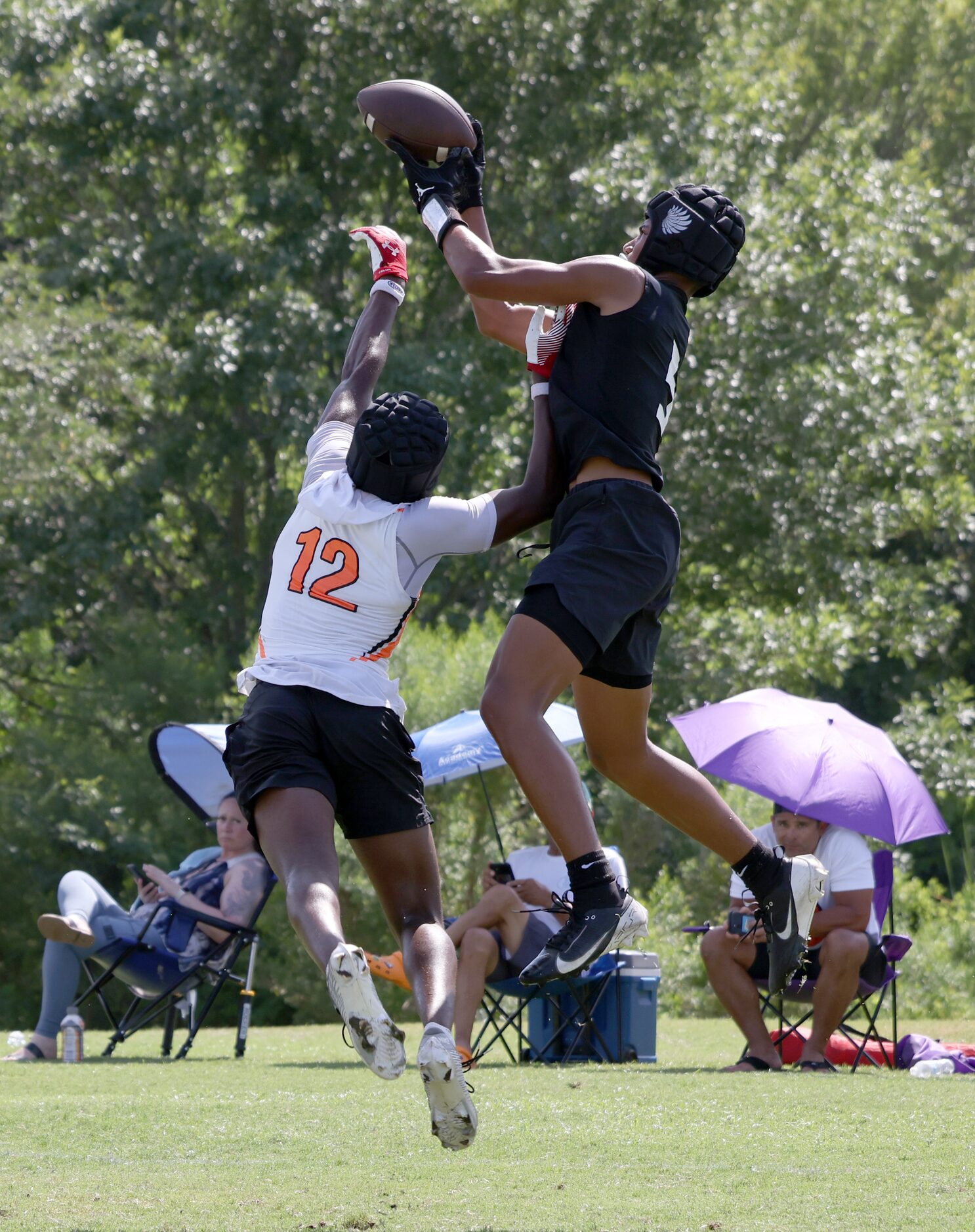 Argyle's Julian Caldwell (5), right, leaps above the contested effort Rockwall's Cameron...