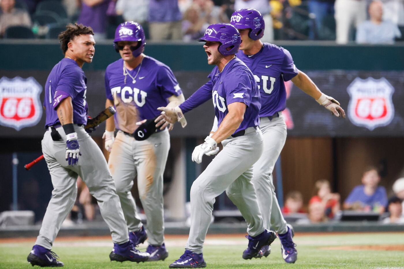 TCU outfielder Luke Boyers (front) cheers after a three run homer during the second inning...
