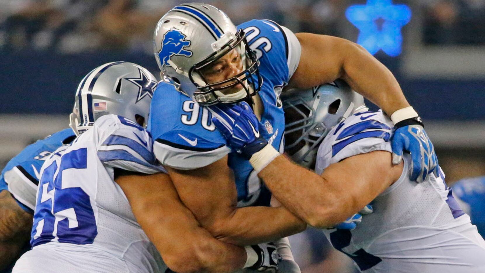 Dallas Cowboys guard Ronald Leary (65) and center Travis Frederick (72) double team Detroit...
