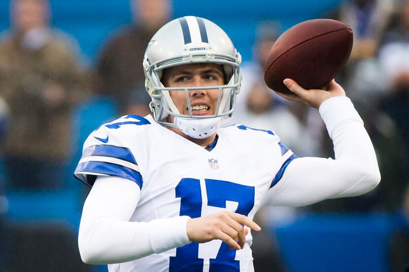 Dallas Cowboys quarterback Kellen Moore warms up before an NFL football game against the...