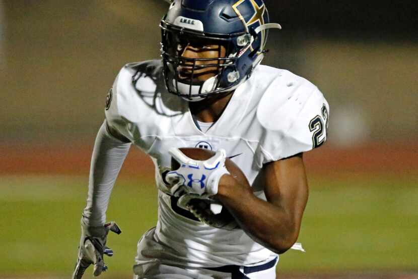 Jesuit running back EJ Smith carries the ball during a game against Coppell in 2017....