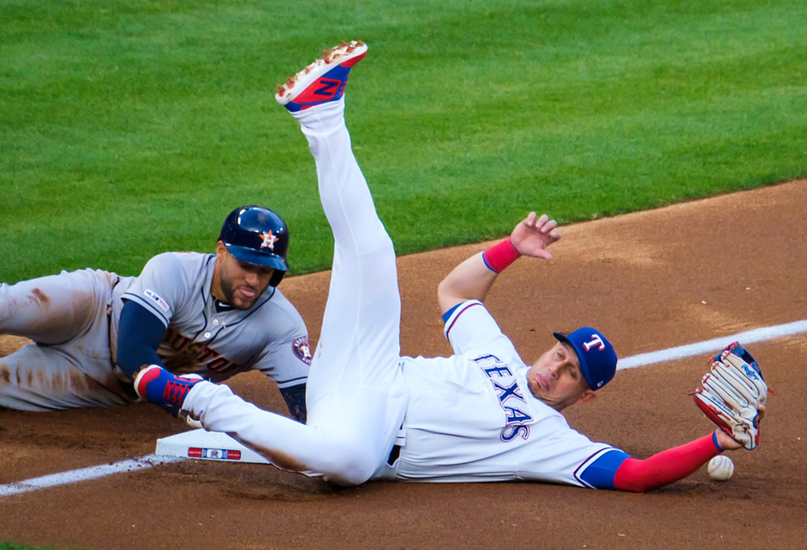 Houston Astros center fielder George Springer is safe with a stolen base as the throw gets...